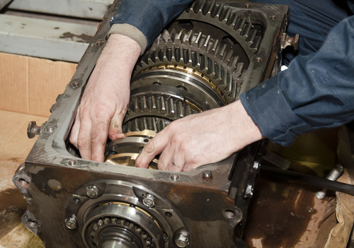 Mechanic performing transmission repair